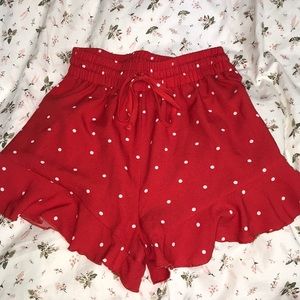 Red shorts with string tie. White polka dots.